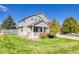 Well-maintained front yard with lush lawn, a white picket fence, and mature trees adding to the home's curb appeal at 3779 Aspen Hollow Ct, Castle Rock, CO 80104
