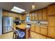 Kitchen with light wood cabinets, stainless steel refrigerator, and center island at 3779 Aspen Hollow Ct, Castle Rock, CO 80104