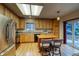 Bright kitchen featuring a central island, stainless steel fridge, light wood cabinets, and sliding glass doors at 3779 Aspen Hollow Ct, Castle Rock, CO 80104