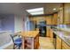 Kitchen featuring a center island, stainless steel refrigerator, and light wood cabinets at 3779 Aspen Hollow Ct, Castle Rock, CO 80104