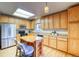 Well-equipped kitchen featuring wooden cabinetry, stainless steel appliances, and a central island with bar stools at 3779 Aspen Hollow Ct, Castle Rock, CO 80104