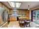 Bright kitchen featuring a skylight, stainless steel appliances, and a kitchen island at 3779 Aspen Hollow Ct, Castle Rock, CO 80104