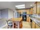 Functional kitchen with wood cabinets, stainless steel appliances, and a central island with seating at 3779 Aspen Hollow Ct, Castle Rock, CO 80104