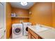 Functional laundry room with washer, dryer, and utility sink at 3779 Aspen Hollow Ct, Castle Rock, CO 80104