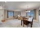 Bright and airy living space with neutral carpet, dining area, and comfortable seating, perfect for entertaining at 3779 Aspen Hollow Ct, Castle Rock, CO 80104