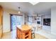 Bright living room seamlessly connects to the kitchen with abundant natural light and a cozy fireplace at 3779 Aspen Hollow Ct, Castle Rock, CO 80104