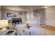 Open-concept living space leading to a carpeted staircase and a hardwood floor entryway at 3779 Aspen Hollow Ct, Castle Rock, CO 80104
