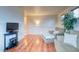 Upstairs area featuring wood floors, comfortable seating, railing, and a television on a black table at 3779 Aspen Hollow Ct, Castle Rock, CO 80104