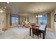 Open-concept living space and dining area, lit by stylish overhead lighting at 3779 Aspen Hollow Ct, Castle Rock, CO 80104