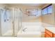 Bathroom featuring a soaking tub, glass shower, neutral walls, and modern fixtures at 3779 Aspen Hollow Ct, Castle Rock, CO 80104