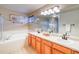 Bright bathroom boasts a soaking tub, glass shower, double sinks, and modern fixtures at 3779 Aspen Hollow Ct, Castle Rock, CO 80104