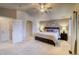 Light and bright main bedroom with ceiling fan, ensuite bathroom, and a large window at 3779 Aspen Hollow Ct, Castle Rock, CO 80104