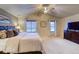 Comfortable main bedroom features a vaulted ceiling, ceiling fan, and two large windows at 3779 Aspen Hollow Ct, Castle Rock, CO 80104