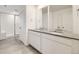 Modern bathroom with double vanity, gray countertops, and tiled floor at 7185 Waterleaf Trl, Littleton, CO 80125