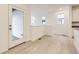 Bright entryway area featuring white walls, light floors, and a glass panel back door at 7185 Waterleaf Trl, Littleton, CO 80125