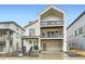 Modern three-story home with white siding, dark trim, balconies, and a two-car garage at 7185 Waterleaf Trl, Littleton, CO 80125