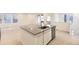 Stylish kitchen island with stainless steel dishwasher, sink and a gray countertop at 7185 Waterleaf Trl, Littleton, CO 80125