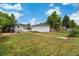 Spacious backyard featuring a well-maintained lawn, patio, and detached garage, perfect for outdoor entertaining and relaxation at 1330 Quebec St, Denver, CO 80220