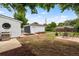 Backyard featuring outdoor seating, garden beds, and a detached garage, perfect for outdoor living at 1330 Quebec St, Denver, CO 80220