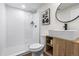 Modern bathroom showcasing white subway tile shower, wood-look vanity, and contemporary fixtures at 1330 Quebec St, Denver, CO 80220
