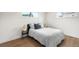 Cozy bedroom with wood flooring and comfortable bed bathed in natural light from the windows at 1330 Quebec St, Denver, CO 80220