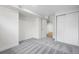 Cozy bedroom featuring soft, patterned carpet and ample natural light from the doorway at 1330 Quebec St, Denver, CO 80220
