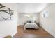 Neutral bedroom with white walls, wood floors, and natural light from the bright windows at 1330 Quebec St, Denver, CO 80220