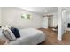 Spacious bedroom with a large window, wood floors, and a sliding door closet at 1330 Quebec St, Denver, CO 80220