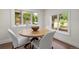 Bright dining area featuring a round table with wood floors and large bright windows at 1330 Quebec St, Denver, CO 80220