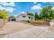 Charming house featuring a detached garage, lush front yard, and meticulous landscaping at 1330 Quebec St, Denver, CO 80220