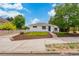 Charming one-story home featuring a well-maintained front lawn, mulch landscaping, and a lovely facade at 1330 Quebec St, Denver, CO 80220