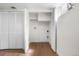 Bright laundry room featuring white bi-fold doors, wood-look floors, and ample space at 1330 Quebec St, Denver, CO 80220
