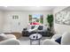 Comfortable living room featuring hardwood floors, a modern sofa, and bright, natural light at 1330 Quebec St, Denver, CO 80220