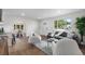 Open living area with hardwood floors, stylish furniture, and natural light that leads to a dining area at 1330 Quebec St, Denver, CO 80220
