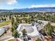 Aerial view of pool, golf course, mature trees and mountain scenery at 18940 Pebble Beach Way, Monument, CO 80132