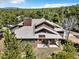 Charming wood home surrounded by lush trees offers great curb appeal at 18940 Pebble Beach Way, Monument, CO 80132