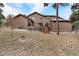 Exterior back view with deck, stairs and mature tree coverage at 18940 Pebble Beach Way, Monument, CO 80132
