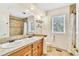 Bathroom featuring a double sink vanity and travertine tile in the shower at 18940 Pebble Beach Way, Monument, CO 80132