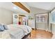 Bedroom with hardwood floors, a bed, and a view into another room at 18940 Pebble Beach Way, Monument, CO 80132