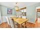 The dining room has wood floors, neutral walls, and a modern chandelier at 18940 Pebble Beach Way, Monument, CO 80132