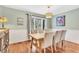 Bright dining room with wood floors, neutral walls, and a modern light fixture at 18940 Pebble Beach Way, Monument, CO 80132