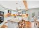 Updated kitchen featuring white cabinets, an island with bar seating, and a wood beam at 18940 Pebble Beach Way, Monument, CO 80132