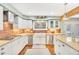 Well-lit kitchen with granite countertops, stainless steel appliances, and white cabinets at 18940 Pebble Beach Way, Monument, CO 80132