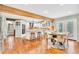 Bright, spacious kitchen featuring wood floors, granite counters, white cabinets, and modern appliances at 18940 Pebble Beach Way, Monument, CO 80132