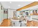 Eat-in kitchen features white cabinets, stainless appliances, and a light green wall color at 18940 Pebble Beach Way, Monument, CO 80132