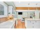 Open kitchen flows to dining area with exposed wood beam and hardwood flooring at 18940 Pebble Beach Way, Monument, CO 80132