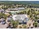 Aerial view of a community pool with waterslide, surrounded by a golf course and forested landscape at 18940 Pebble Beach Way, Monument, CO 80132