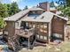 Two-story home with a wooden deck, stairs, and hot tub at 18940 Pebble Beach Way, Monument, CO 80132