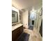 Bathroom with a granite-topped vanity, walk-in shower and tile flooring at 13126 W Warren Cir, Lakewood, CO 80228