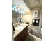 Well-lit bathroom featuring a granite vanity, decorative mirror, and a shower-tub combo at 13126 W Warren Cir, Lakewood, CO 80228